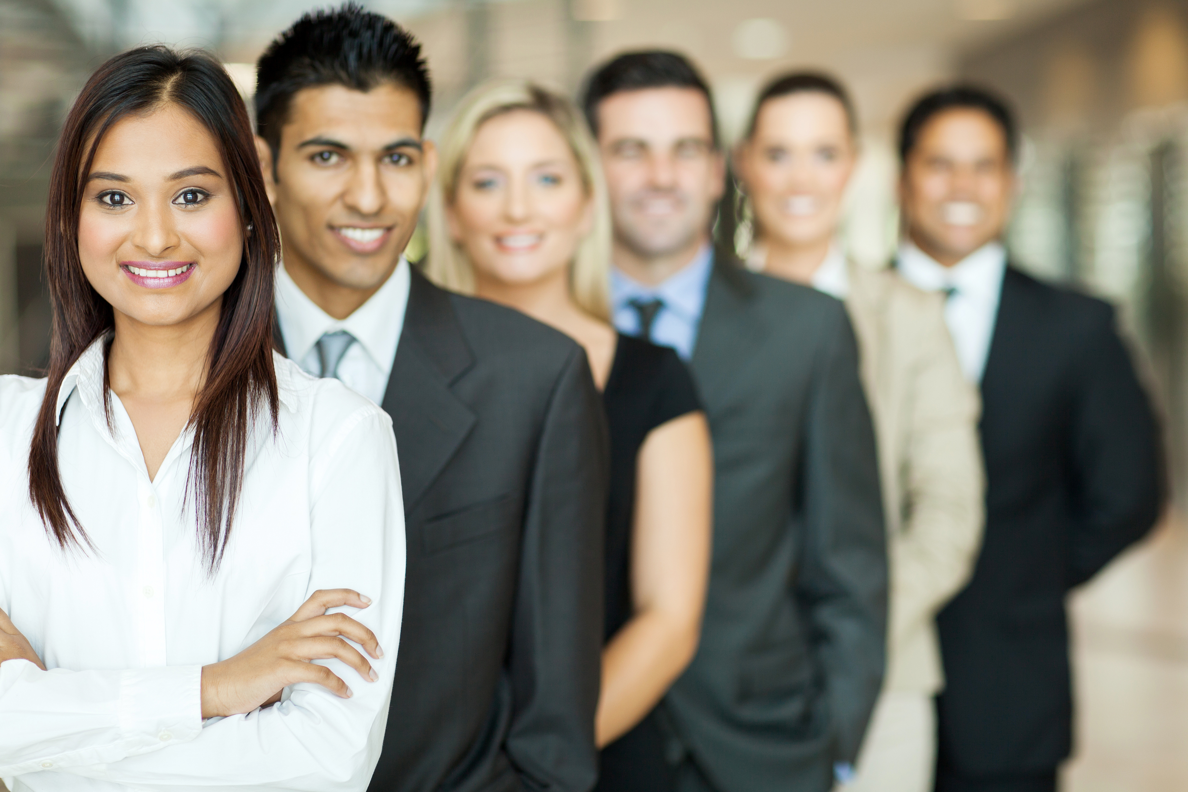 Line of diverse professionals smiling at camera