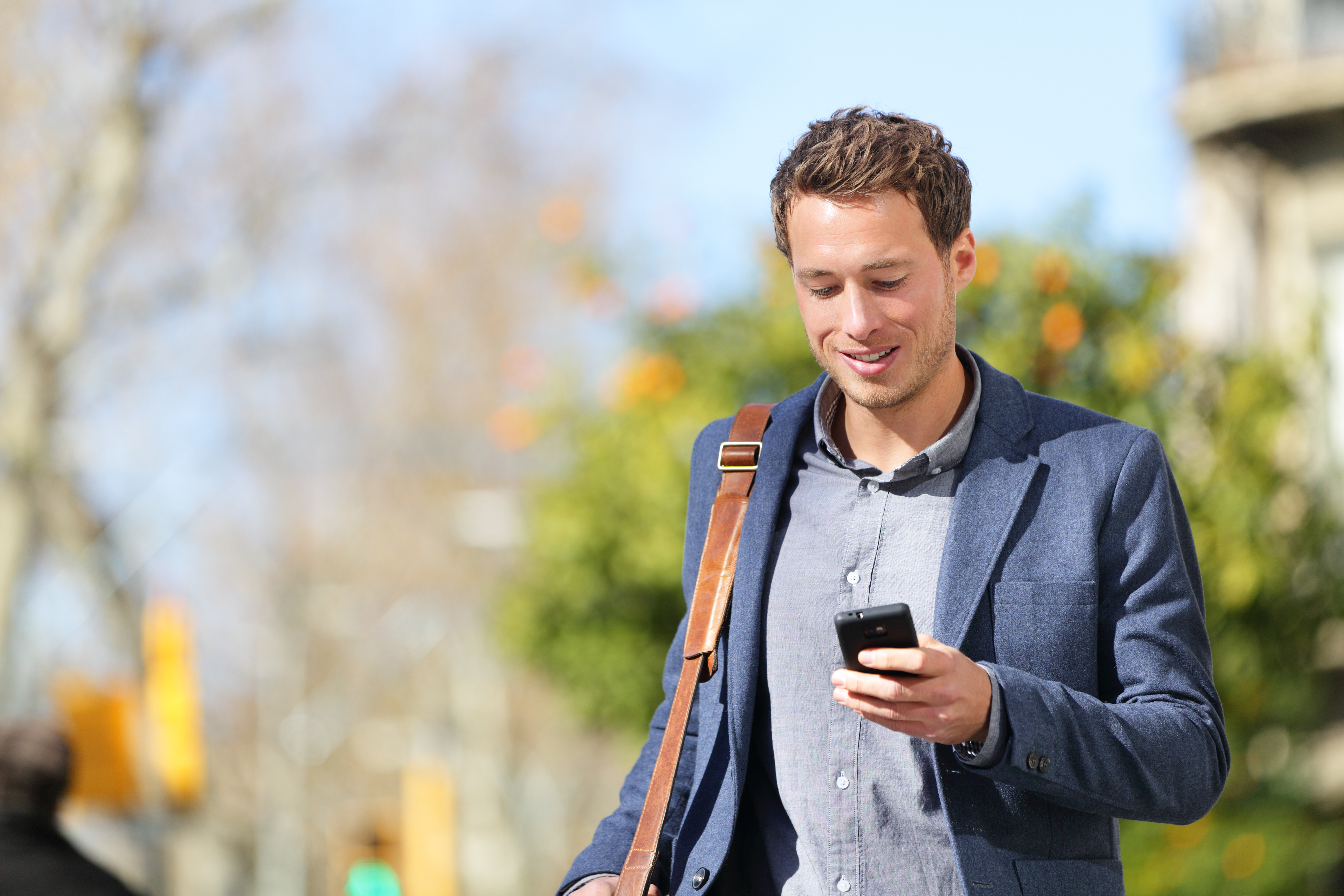 Professional looking at phone while outside