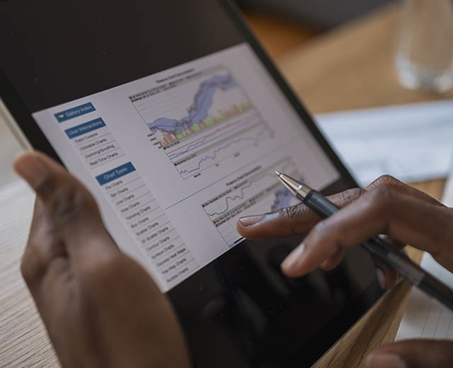 A person's hands using a digital tablet.